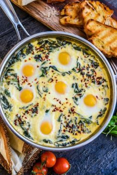 Baked Eggs in Ricotta Parmesan Creamed Spinach - 30 Easy And Delicious Egg Recipes