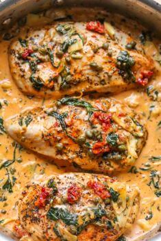 Creamy Tuscan Chicken with Spinach Artichokes Sun Dried Tomatoes Capers - 30 Best Garlic Chicken Recipes That You Never Forget
